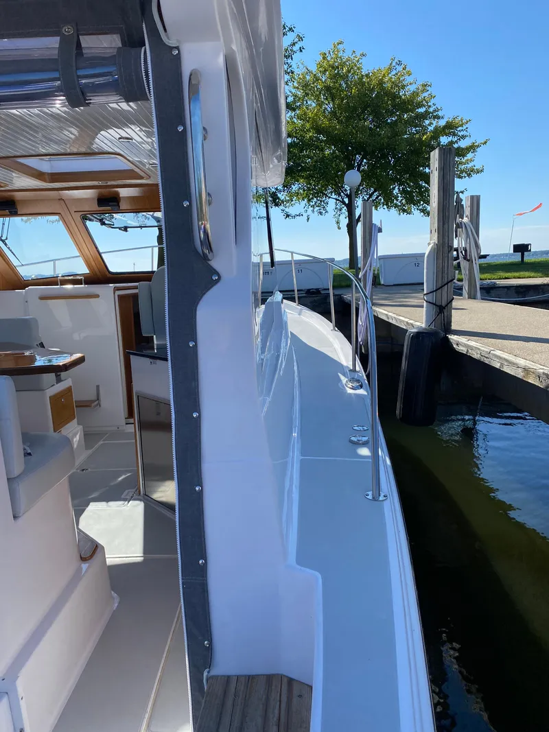 Slide: The Image of 2023 True North 34 Outboard Express docked, showcasing sleek design and spacious interior. - 15