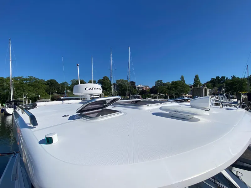 Slide: The Image of 2023 True North 34 Outboard Express boat docked, featuring Garmin equipment under a clear blue sky. - 18