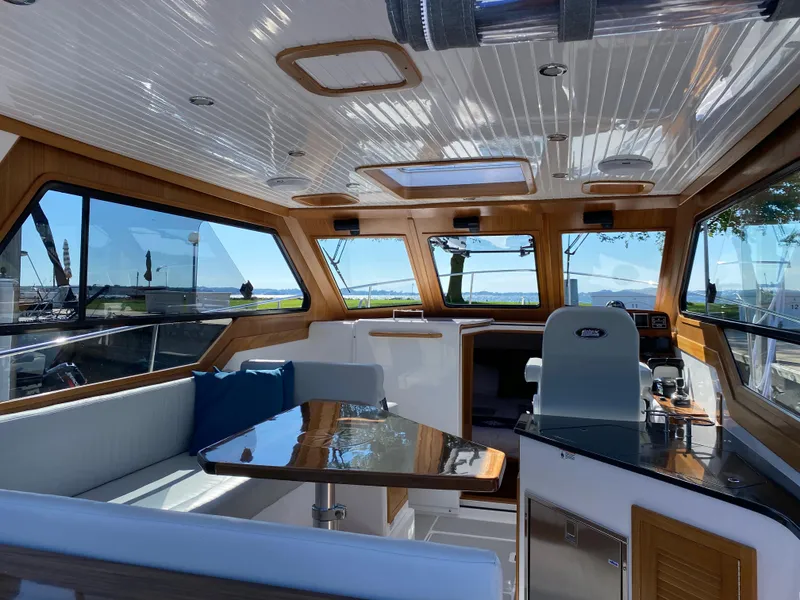 Slide: The Image of Interior of 2023 True North 34 Outboard Express boat with seating and helm. - 19
