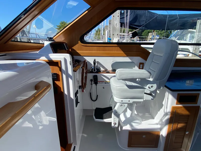 Slide: The Image of 2023 True North 34 Outboard Express helm with luxurious seating and wooden accents. - 20