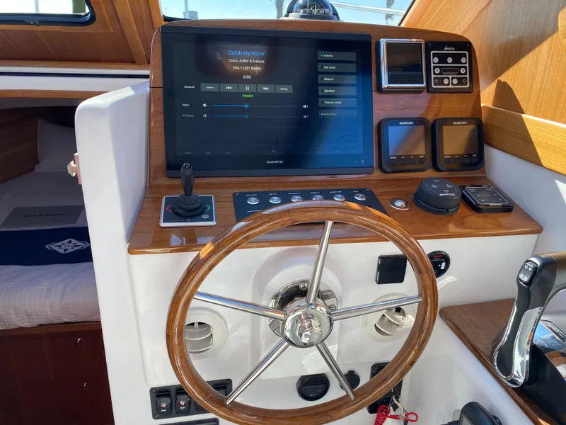 Slide: The Image of 2023 True North 34 Outboard Express helm with advanced navigation and control systems. - 22