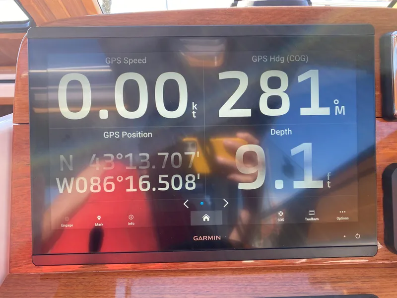 Slide: The Image of Garmin navigation display on 2023 True North 34 Outboard Express, showing speed, heading, and depth. - 24
