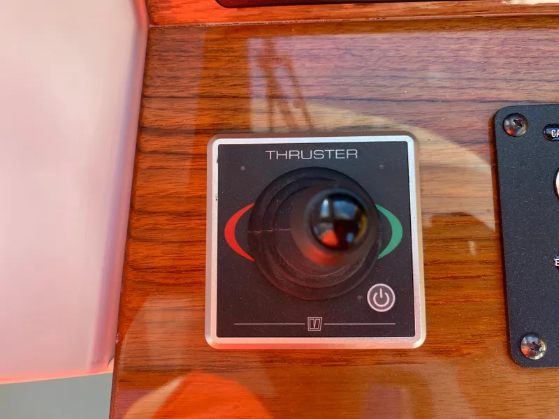 Slide: The Image of Thruster control panel on 2023 True North 34 Outboard Express boat dashboard. - 28