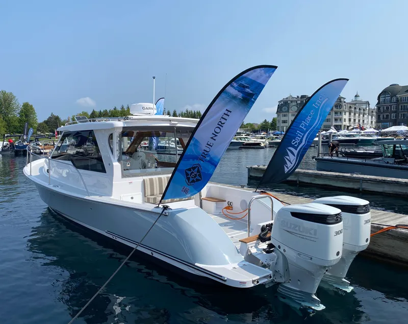 Slide: The Image of 2023 True North 34 Outboard Express boat docked with Suzuki engines. - 3