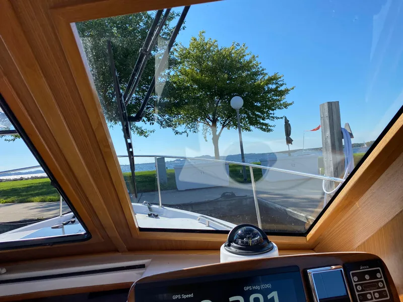 Slide: The Image of Interior view from 2023 True North 34 Outboard Express boat, overlooking a scenic waterfront. - 32