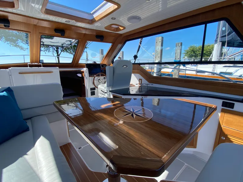 Slide: The Image of Luxurious interior of 2023 True North 34 Outboard Express yacht with wooden accents and skylights. - 36