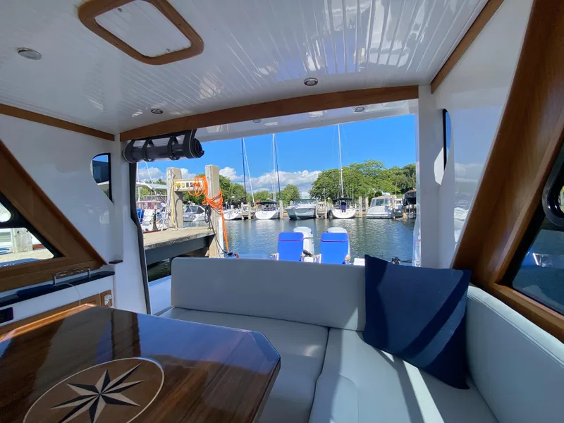 Slide: The Image of Interior view of 2023 True North 34 Outboard Express yacht at marina. - 38