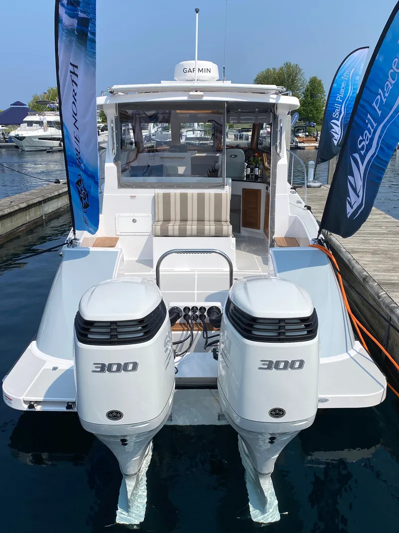 Slide: The Image of 2023 True North 34 Outboard Express boat with twin 300 engines docked at marina. - 4