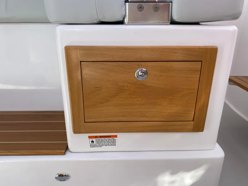 Slide: The Image of 2023 True North 34 Outboard Express, wooden storage compartment detail. - 40