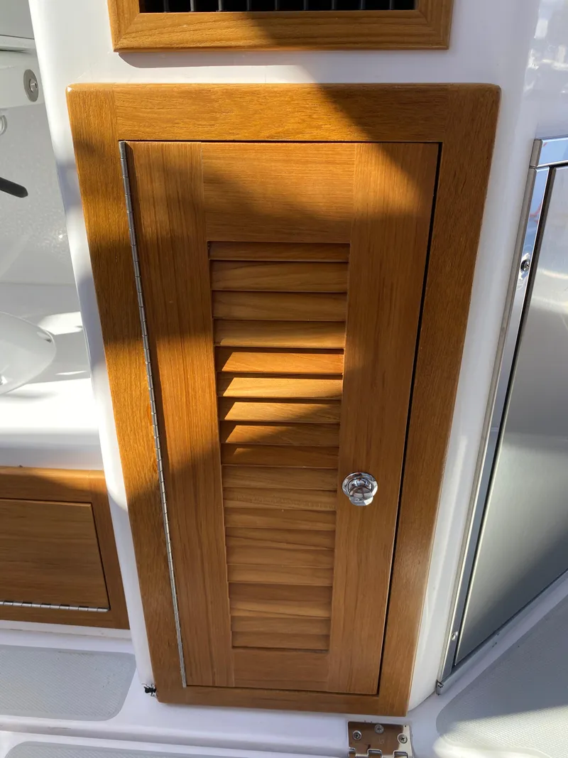 Slide: The Image of Wooden cabinet door on 2023 True North 34 Outboard Express boat interior. - 42