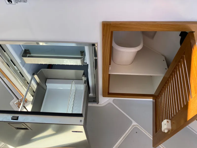 Slide: The Image of 2023 True North 34 Outboard Express interior storage and refrigerator detail. - 44