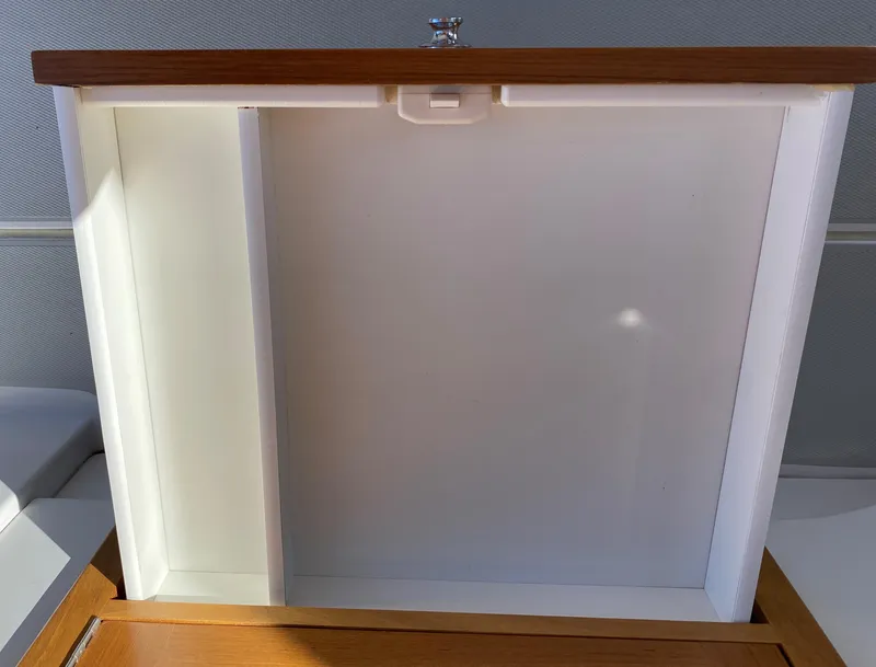 Slide: The Image of Open storage compartment on 2023 True North 34 Outboard Express boat. - 49