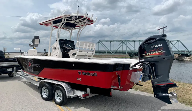 Slide: The Image of 2019 Wellcraft 241 Bay boat on trailer with Yamaha outboard motor. - 13
