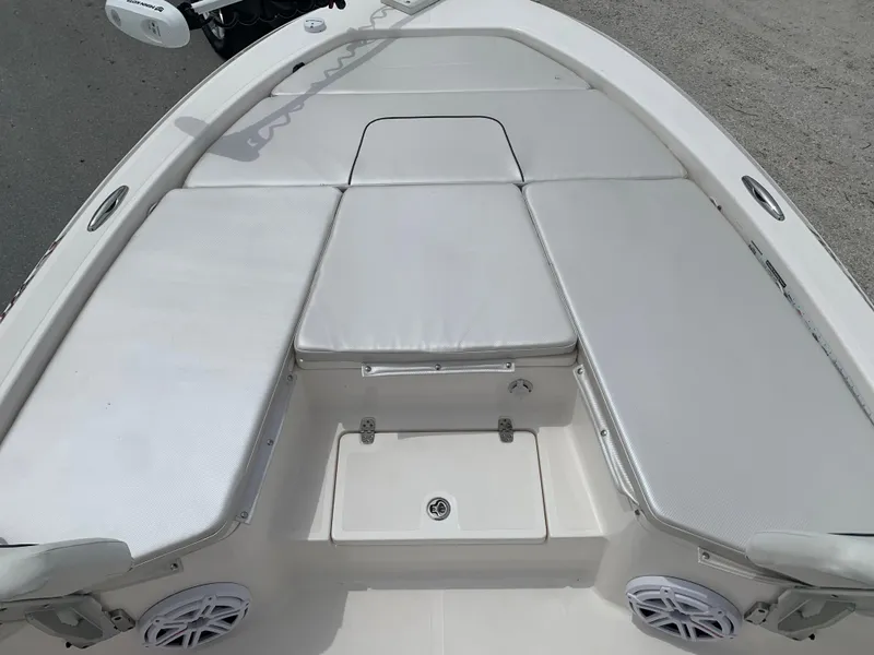 Slide: The Image of 2019 Wellcraft 241 Bay boat with cushioned seating and storage compartments. - 17