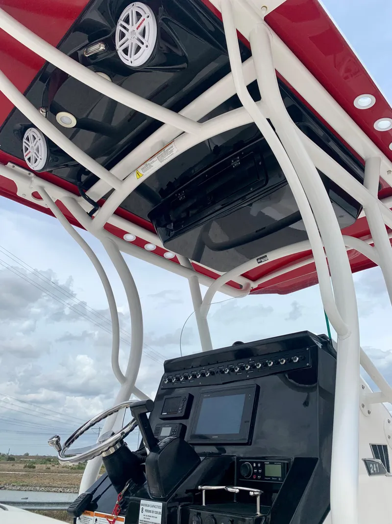 Slide: The Image of 2019 Wellcraft 241 Bay boat console with electronics and T-top speakers. - 19