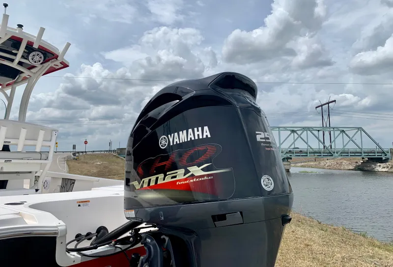 Slide: The Image of 2019 Wellcraft 241 Bay boat with Yamaha VMAX 250 outboard motor by a river. - 20