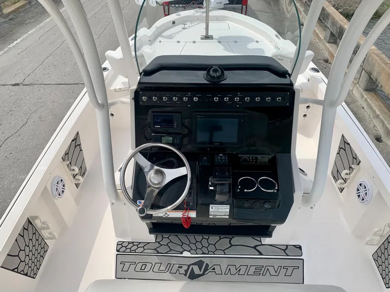 Slide: The Image of 2019 Wellcraft 241 Bay boat console with steering wheel and electronic controls. - 26