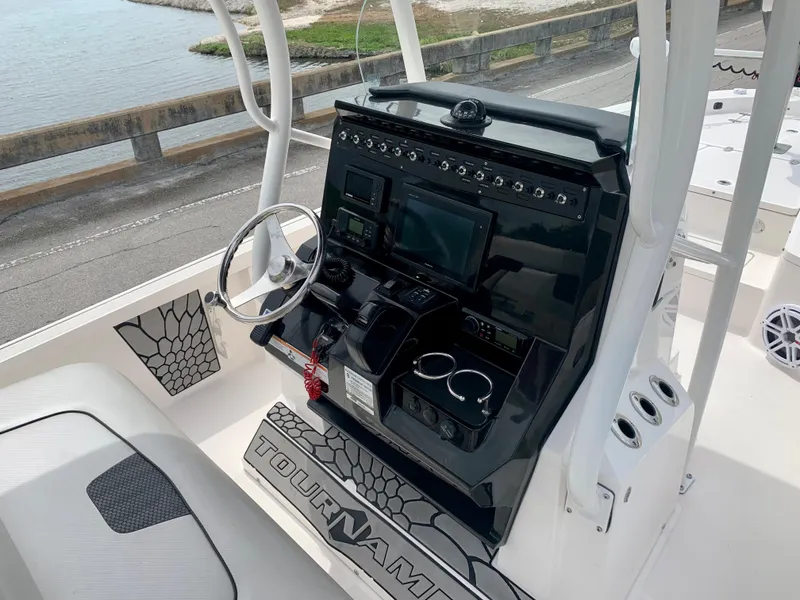 Slide: The Image of 2019 Wellcraft 241 Bay boat console with steering wheel and navigation controls. - 27