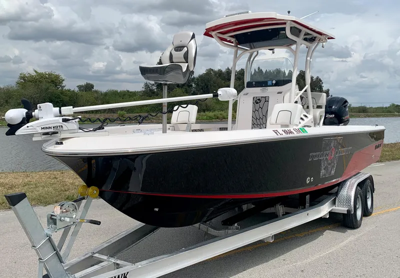 Slide: The Image of 2019 Wellcraft 241 Bay boat on trailer by a river under cloudy sky. - 3