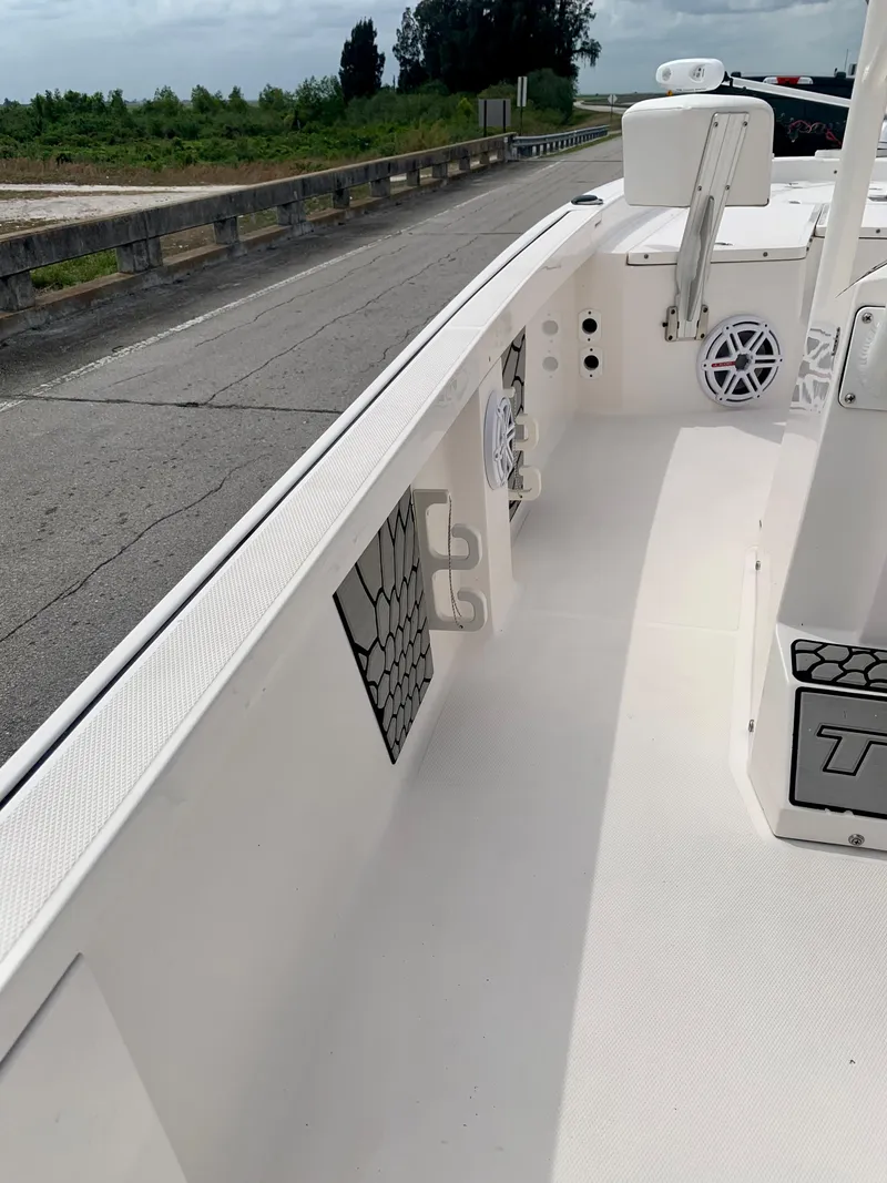 Slide: The Image of 2019 Wellcraft 241 Bay boat interior, white deck, and storage compartments. - 32