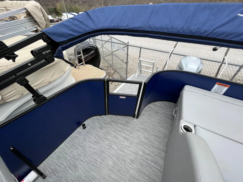 Slide: The Image of 2021 Bennington 22 SSLXP pontoon boat interior with blue panels and gray seating. - 10