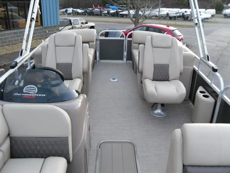 Slide: The Image of 2023 Sun Tracker PARTY BARGE® 22 XP3 interior with beige seating and spacious layout. - 16