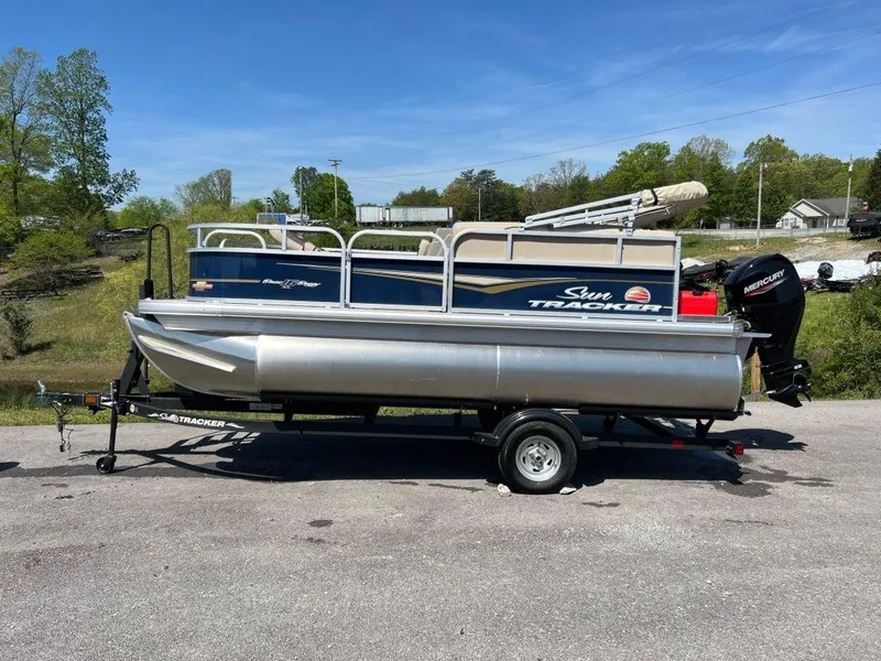 The Image of 2023 Sun Tracker Bass Buggy® 16 XL Select pontoon boat on trailer. - 1