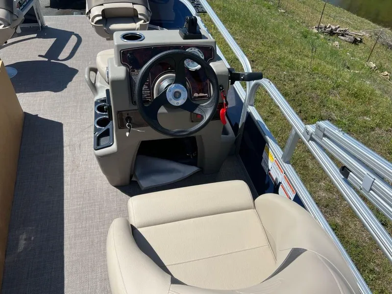 Slide: The Image of 2023 Sun Tracker Bass Buggy® 16 XL Select pontoon boat interior with steering console and seating. - 4
