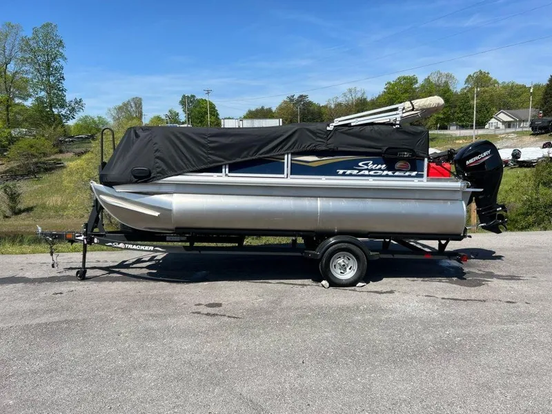 Slide: The Image of 2023 Sun Tracker Bass Buggy® 16 XL Select pontoon boat on trailer, covered. - 5