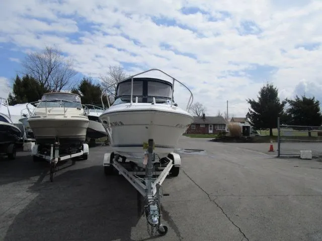 Slide: The Image of 1989 Sea Ray 230 Cuddy boat on trailer in outdoor lot. - 2