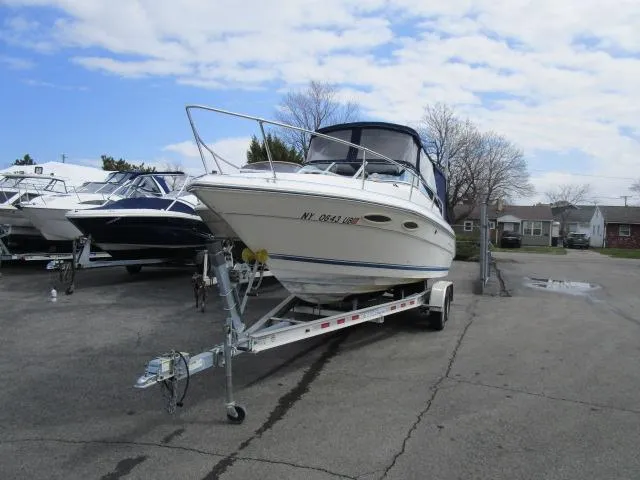 Slide: The Image of 1989 Sea Ray 230 Cuddy boat on a trailer in a marina. - 3