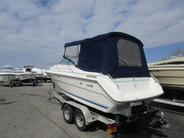 Slide: The Image of 1989 Sea Ray 230 Cuddy boat on a trailer with a blue canvas cover. - 5