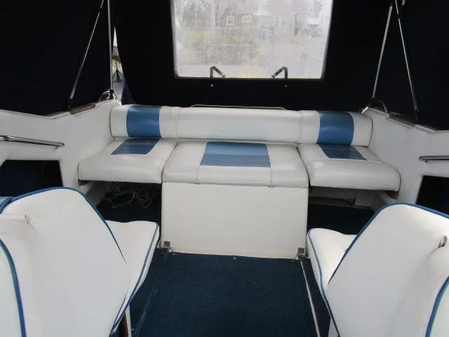 Slide: The Image of Interior of 1989 Sea Ray 230 Cuddy with white and blue seating. - 8