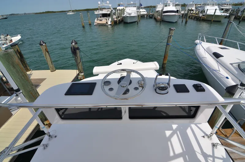 Slide: The Image of Helm of a 1993 Gamefisherman Open boat docked at marina. - 14