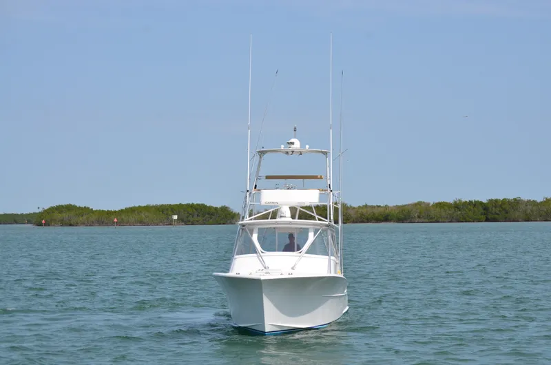 Slide: The Image of 1993 Gamefisherman Open boat on calm water. - 2