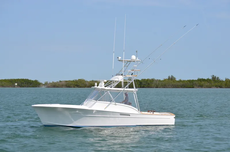 Slide: The Image of 1993 Gamefisherman Open boat on calm water. - 3