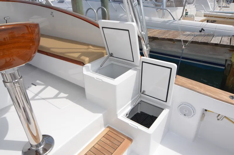 Slide: The Image of 1993 Gamefisherman Open boat with open storage compartments at dock. - 30