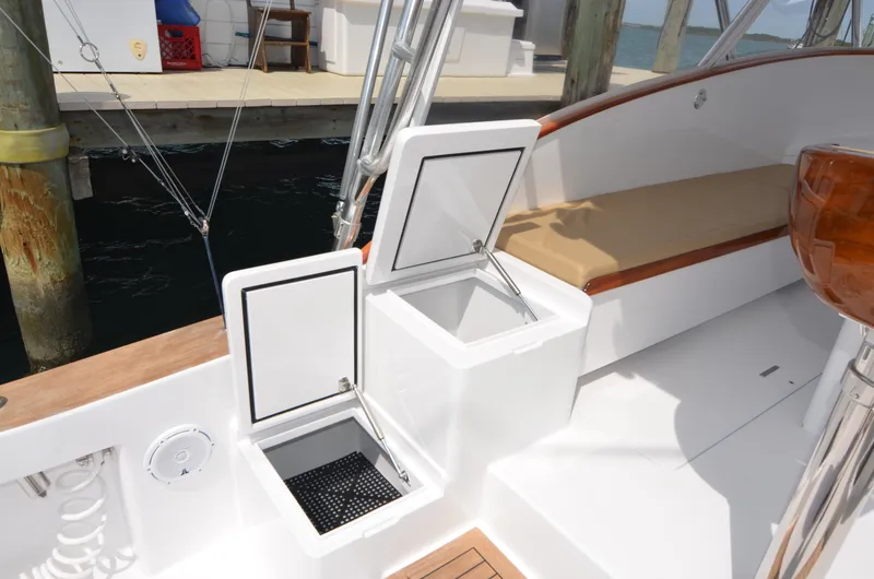 Slide: The Image of 1993 Gamefisherman Open boat with storage compartments and seating at the dock. - 31