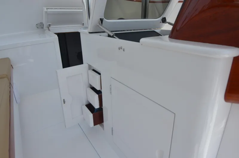 Slide: The Image of Interior of a 1993 Gamefisherman Open boat with storage compartments. - 32