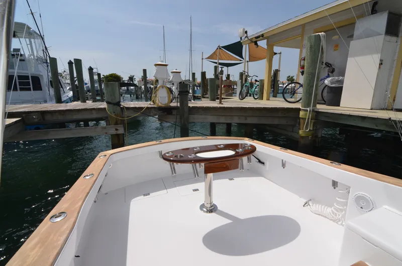 Slide: The Image of 1993 Gamefisherman Open boat at dock with fishing rod holder. - 36