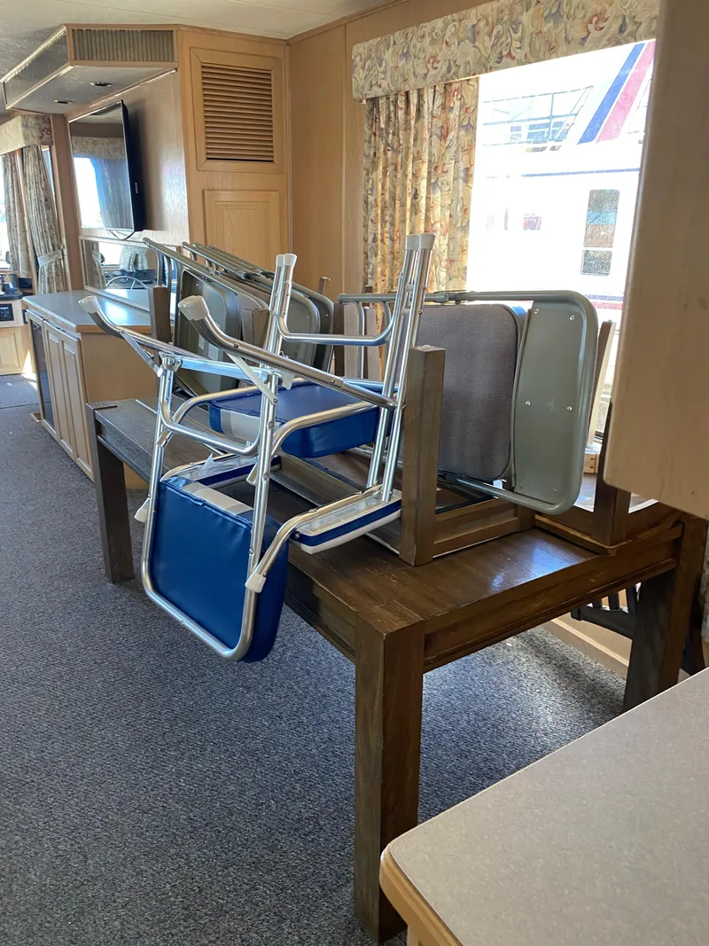 Slide: The Image of Interior of 2001 Stardust Cruisers Summer Dreamin' Trip with stacked chairs on a table. - 17