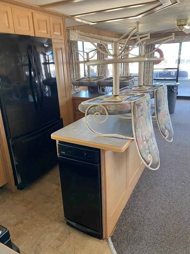 Slide: The Image of Interior of 2001 Stardust Cruisers Summer Dreamin' Trip, featuring kitchen with black appliances. - 18