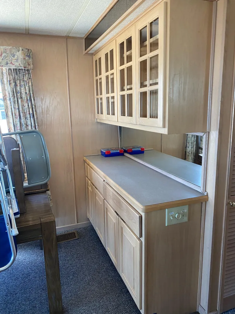 Slide: The Image of 2001 Stardust Cruisers Summer Dreamin' interior with wooden cabinets and carpeted floor. - 20