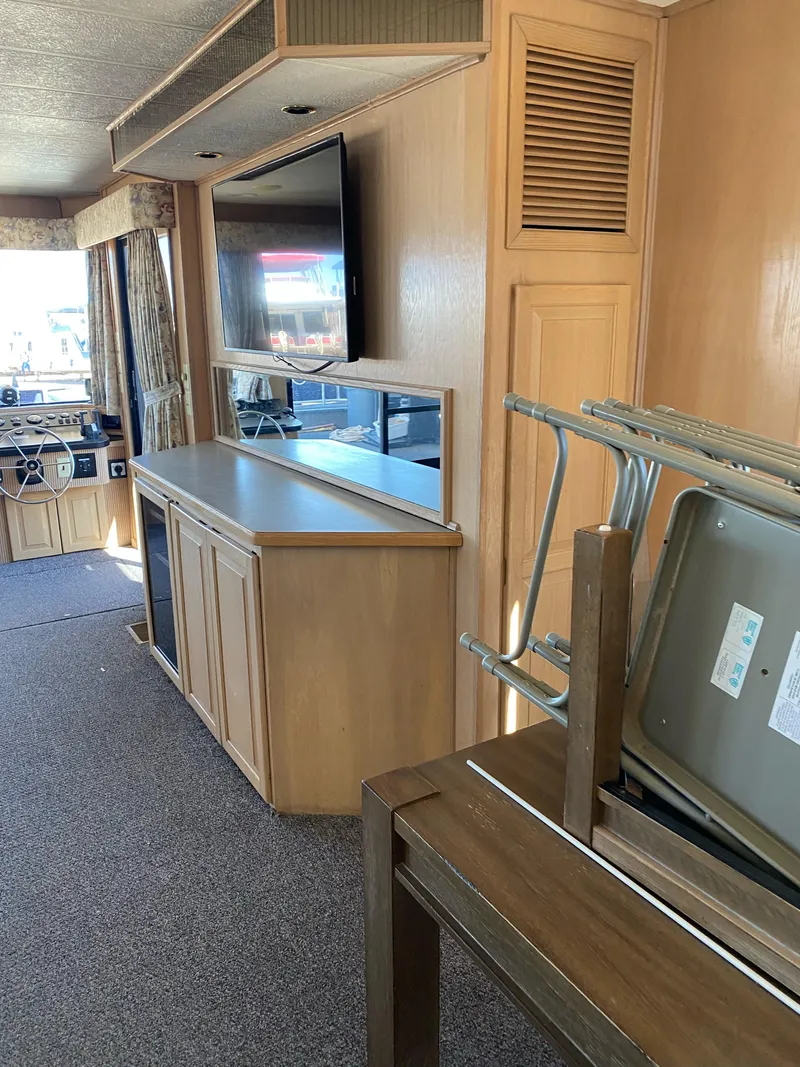 Slide: The Image of Interior of 2001 Stardust Cruisers Summer Dreamin' Trip, featuring wood cabinetry and a mounted TV. - 26