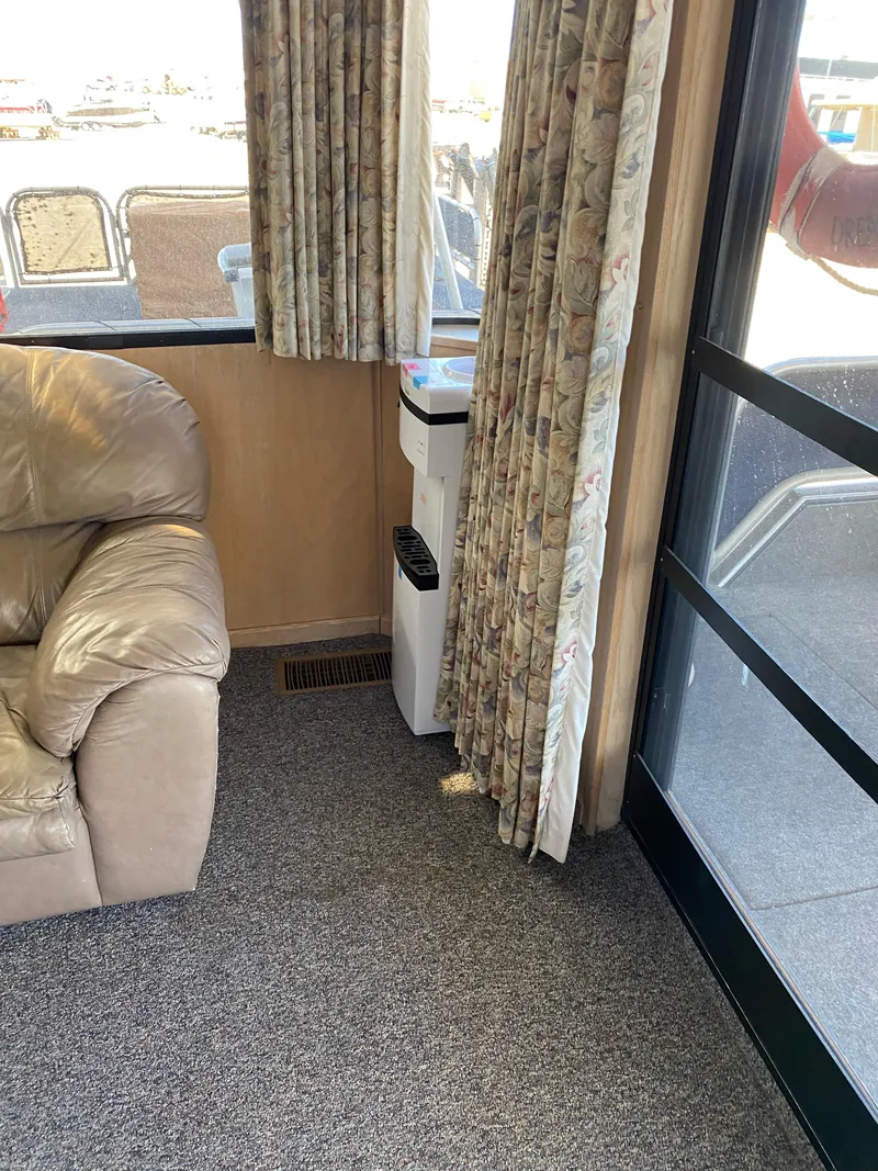 Slide: The Image of Interior of 2001 Stardust Cruisers Summer Dreamin' Trip, featuring a leather sofa and floral curtains. - 27