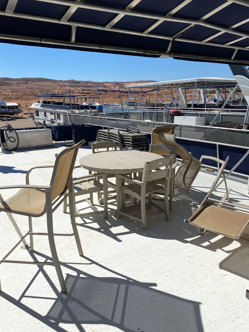 Slide: The Image of Outdoor deck of 2001 Stardust Cruisers houseboat with seating, overlooking marina and desert landscape. - 36