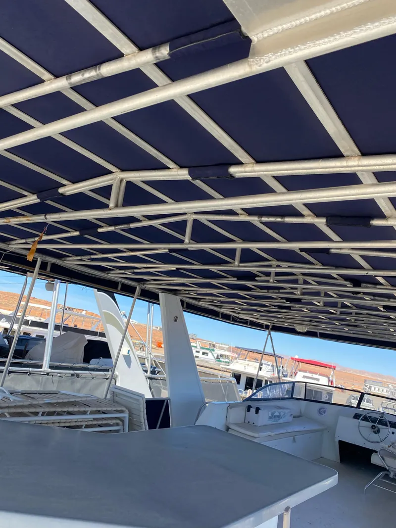 Slide: The Image of 2001 Stardust Cruisers Summer Dreamin' Trip boat interior with blue canopy and seating area. - 37