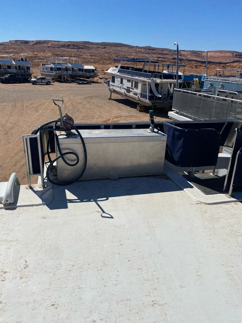 Slide: The Image of 2001 Stardust Cruisers Summer Dreamin' Trip 37 and 38 houseboats docked in a desert marina. - 39