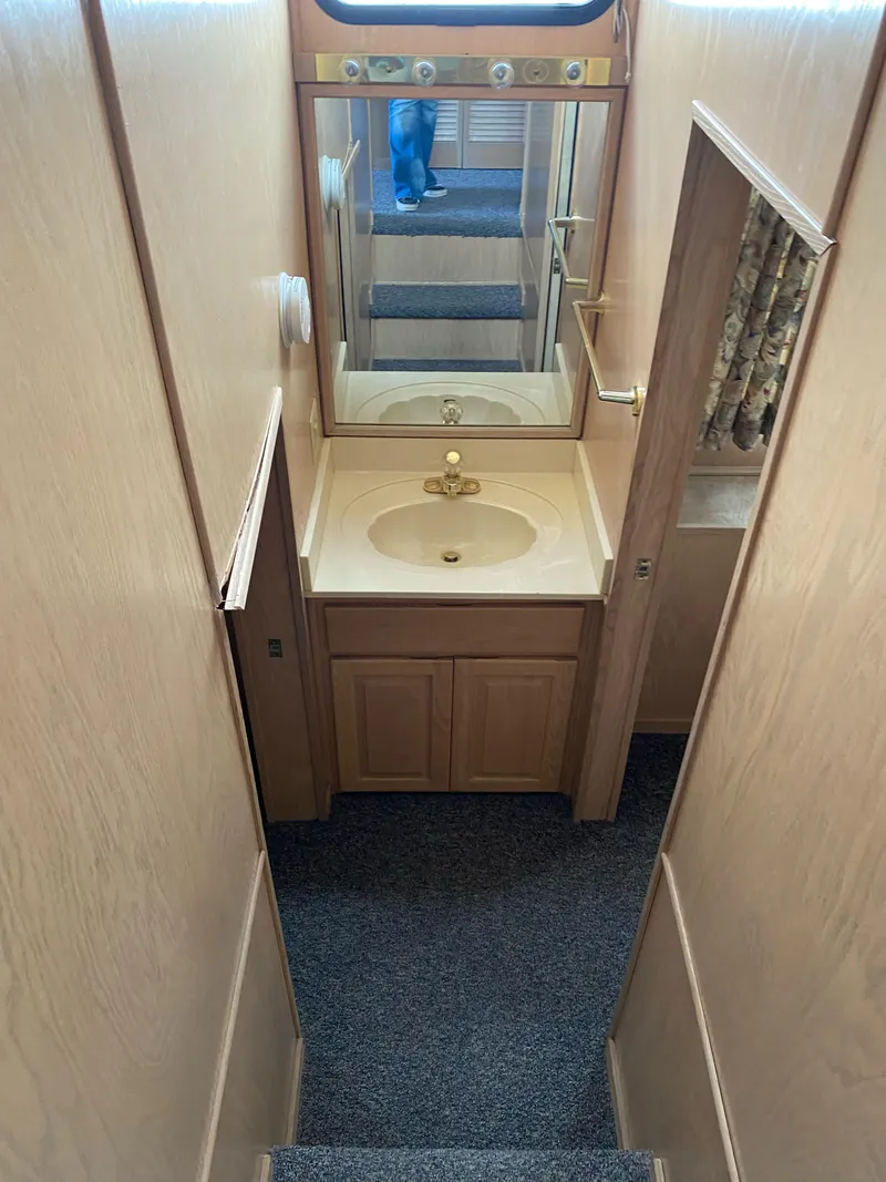 Slide: The Image of 2001 Stardust Cruisers bathroom with wooden cabinetry, mirror, and sink. - 9