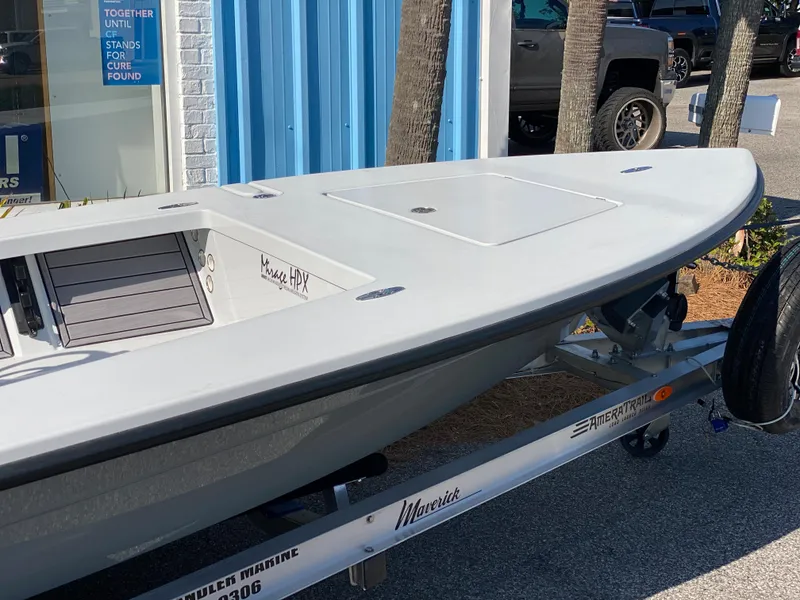Slide: The Image of 2024 Maverick 17 HPX-V boat on trailer outside blue building. - 6
